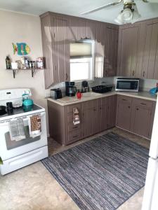 a kitchen with wooden cabinets and a white stove top oven at Binghamton Studio in Binghamton