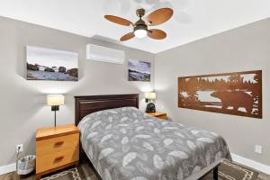 a bedroom with a bed and a ceiling fan at Chims Cabins - Port Alberni in Port Alberni