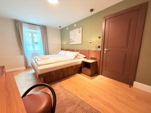 a small bedroom with a bed and a door at Amaroo - Boarding & Serviced Apartments "Regia" in Potsdam