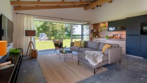 a living room with a couch and a table at Ferienhof Schnurrum in Emmelsbüll-Horsbüll