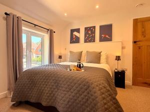 a bedroom with a large bed and a window at Unique Devon Cottages - Sunrise Cottage in Exmouth