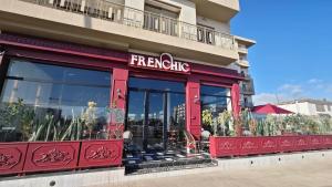 a fast food restaurant with a red facade at Nouaceur Garden Airport Casablanca in Nouaseur