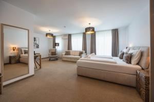 a living room with a large bed and a mirror at Casa Plus in Villach