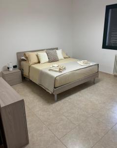 a bed sitting in a room with at La Dimora di Valesio in Torchiarolo