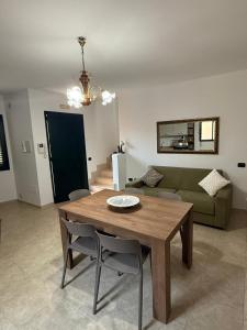 a living room with a wooden table and a couch at La Dimora di Valesio in Torchiarolo