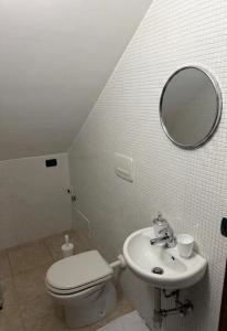 a bathroom with a toilet and a sink and a mirror at La Dimora di Valesio in Torchiarolo