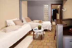 a living room with two beds and a table at Le Terrace in Morro de São Paulo