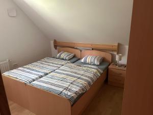 a bed with two pillows on it in a room at MMMM in Bovec