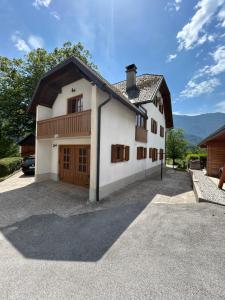 a large white house with a garage at MMMM in Bovec