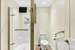 a bathroom with a white toilet and a shower at Chims Cabins - Port Alberni in Port Alberni +33 photos