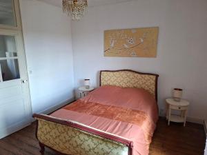 a bedroom with a bed and two night tables at havre de paix in Saint-Junien +5 photos