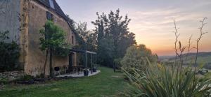 a building with a picnic table in front of it at Le Peyroutet in Cazaux-Villecomtal +22 photos
