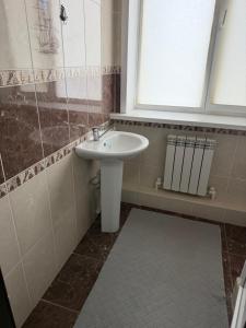 a bathroom with a sink and a window at Посейдон ЖМ Амангельды ул Тепличная 4 in Kostanay