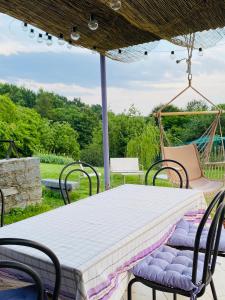 a table and chairs under an umbrella on a patio at La Cà di Carol in Tollegno