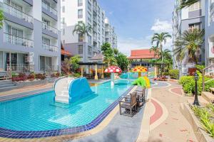 a swimming pool with a water slide at a resort at Hin Nan Hua Hin RELAX in Hua Hin