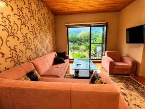 a living room with a large couch and a table at Green dream House in Lankaran