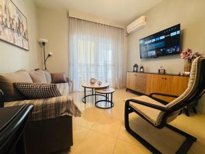 a living room with a couch and a table at Coastal Heaven in Neoi Epivates