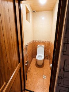 a bathroom with a toilet in a small room at Green dream House in Lankaran +4 photos