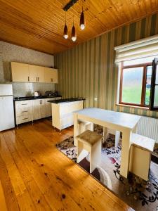 a kitchen with a white table in a room at Green dream House in Lankaran