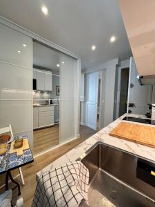 a kitchen with white cabinets and a table at La suite de Elise in Beaulieu-sur-Mer +5 photos