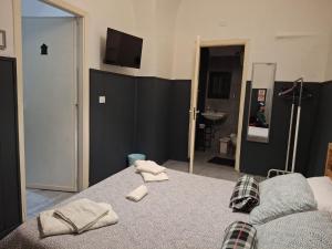 a bedroom with a bed with two towels on it at Palazzo Ruisi in Scordia
