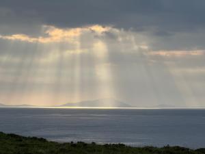 a ray of light shining over a body of water at Luxury Nordic Lodge with private Sauna in Glendale +49 photos