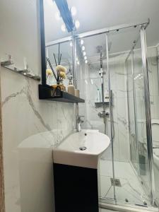 a bathroom with a white sink and a shower at Coastal Heaven in Neoi Epivates +50 photos