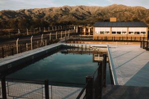 a pool of water in front of a building at Takuá Hotel Serrano in La Punta