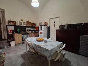 a kitchen with a table with a bowl of fruit on it at Palazzo Ruisi in Scordia