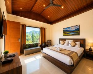 a bedroom with a large bed and a large window at Skywood by Vankuteer - Pool & Mountain view Rooms in Kandāghāt +19 photos