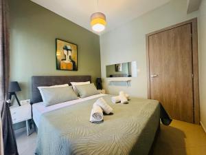 a bedroom with two beds with towels on them at Coastal Heaven in Neoi Epivates