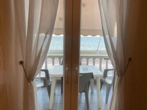 a dining room with a table and a view of the ocean at Tsatsoni Studios in Velika