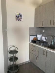a kitchen with a counter and a stool in it at Tsatsoni Studios in Velika +116 photos