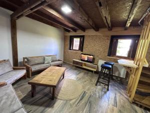 a living room with a couch and a table at Stanetestruzhes in Prizren
