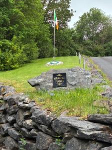 a sign on a rock with a flag on top of it at Ríocht Fódla 2 in Killarney