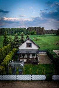 a house in the middle of a green field at SOCHÓWKA nad Jeziorem Skarlińskim in Kurzętnik +10 photos