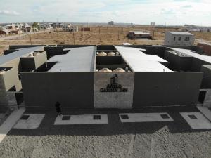 a man standing on the roof of a building at Añelo Garden Inn in Añelo