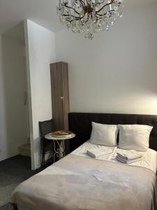 a bedroom with a bed and a chandelier at Studio 11T Sleeps 2 with WiFi in Beausoleil +17 photos