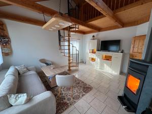 a living room with a couch and a fireplace at FH Waldidylle Nähe Torgau, Seebad Neumühle in Schildau