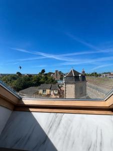 a view from an open window of a building at Le Nuage - Vidéoprojecteur - Terrasse - 5min Gare in Ploumagoar
