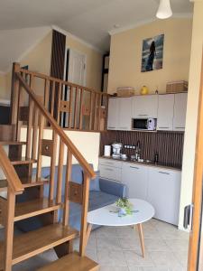 a kitchen with a staircase and a table in a room at Sea view and more in Bŭnzareto