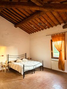 a bedroom with a bed and a large window at Podere Tre Berte - The Sleeping Beauty in Acquaviva