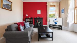 a living room with a couch and a table at Ardyne House in Port Bannatyne