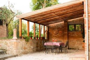 a patio with a table and chairs under a pavilion at Podere Tre Berte - The Sleeping Beauty in Acquaviva +31 photos