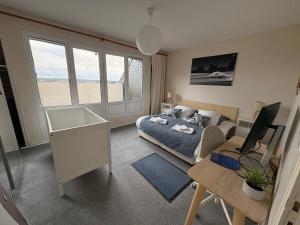 a living room with a bed and a desk and a couch at Ty avel in Crozon