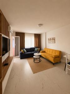 a living room with a couch and a table at Kron apartment in Shëngjin