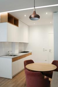 a kitchen with a table and chairs and a sink at Airen Hotel Velipoje in Velipojë