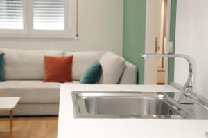 a living room with a sink and a couch at Airen Hotel Velipoje in Velipojë +51 photos