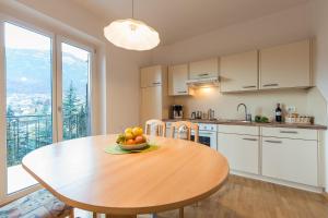 a kitchen with a table with a bowl of fruit on it at Haus Dorfblick in Caldaro