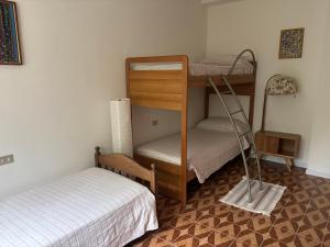 a room with two bunk beds and a bed at Patty House in Colico